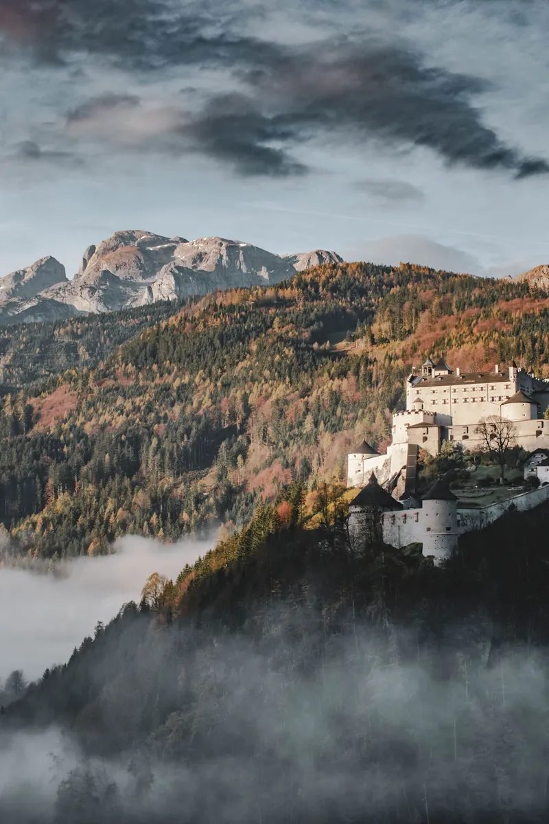 Fortress Hohenwerfen crowning its rock above the Salzach valley near Werfen, Austria, ringed by the peaks of the Tennengebirge.